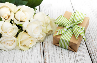 White roses and gift box