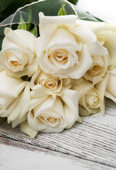 White roses on a wooden table
