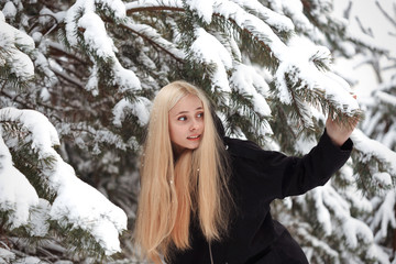 girl in a snowy winter forest. slum