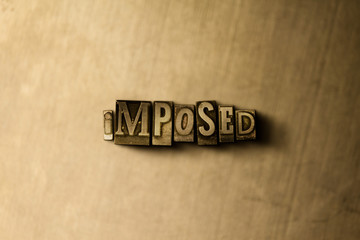 IMPOSED - close-up of grungy vintage typeset word on metal backdrop. Royalty free stock - 3D rendered stock image.  Can be used for online banner ads and direct mail.