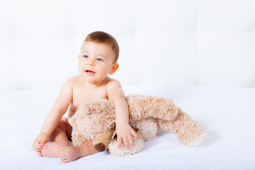 Baby with blue eyes smiling on white background