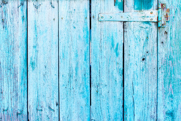 A wooden blue color door hinge closeup