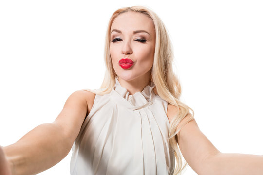 Blonde doing selfie on isolated white background. Taking picture.