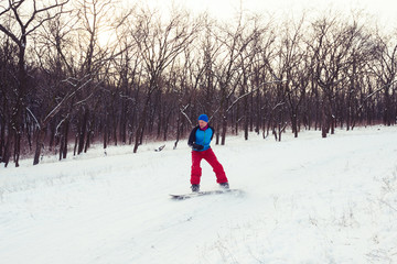 Bearded man is riding on the snowboard