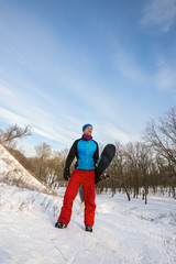Smiling bearded man with snowboard