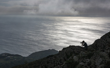 PENINHA, SERRA DE SINTRA, PORTUGAL - OCTOBER 18, 2014: The photographer is tacking pictures of the landscape from the highest viewpoint of Sintra region