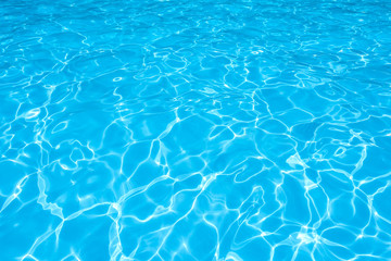 Blue and bright water surface and ripple wave in swimming pool