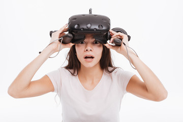 Confused young woman wearing virtual reality device