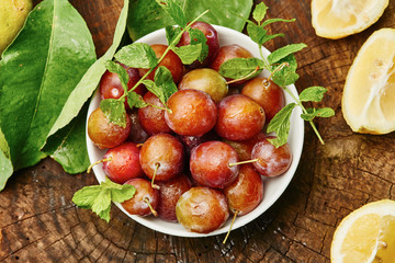 Plums in bowl on wood