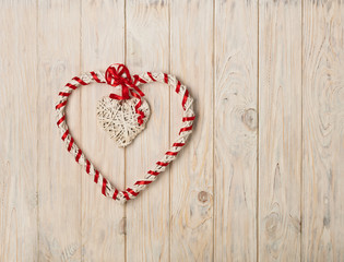 Valentine's day concept. Decor heart vines on a light wooden bac