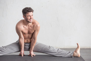A man doing yoga exercises