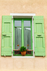 Window with shutters in Mediterranean ambience.
Cheerful summer colors.