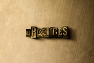 Obraz premium UPDATES - close-up of grungy vintage typeset word on metal backdrop. Royalty free stock - 3D rendered stock image. Can be used for online banner ads and direct mail.