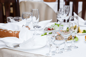 Cutlery and cold cuts served on a festive table in restaurant