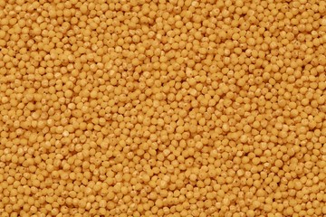 yellow millet groats background on the table top view