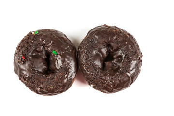 Chocolate frosted cake donuts isolated on a white background