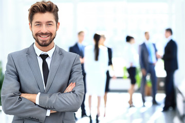 Happy mature business man looking at camera with satisfaction at office