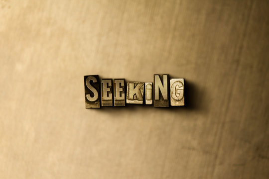 SEEKING - close-up of grungy vintage typeset word on metal backdrop. Royalty free stock - 3D rendered stock image.  Can be used for online banner ads and direct mail.