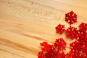 Wooden background, red snowflakes.