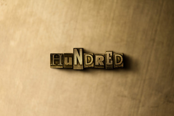 HUNDRED - close-up of grungy vintage typeset word on metal backdrop. Royalty free stock - 3D rendered stock image.  Can be used for online banner ads and direct mail.