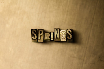 Obraz premium SPRINGS - close-up of grungy vintage typeset word on metal backdrop. Royalty free stock - 3D rendered stock image. Can be used for online banner ads and direct mail.