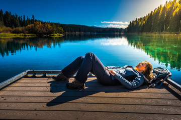 Hiker resting on a deck by the Clear Lake Oregon