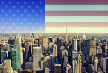 New York city skyline with American flag in background.