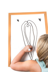 Young girl drawing on a dry erase board with a marker