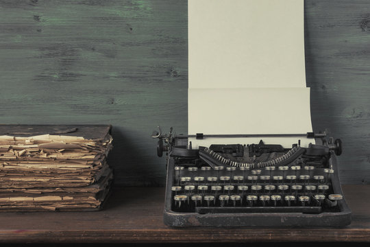 Typewriter with paper and old books