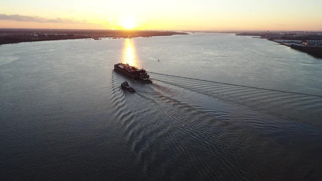 Aerial Footage of Tugboats  and Barge on Delaware River Philadelphia PA Sunset
