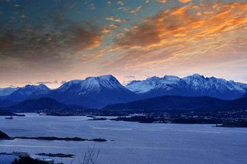 Winter Norwegian Landscape with Ocean and mountains during sunrise