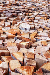 Stacked chopped firewood vertical texture background