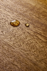 Water droplets on a wooden surface