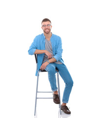 Young man sitting on the chair isolated over white background