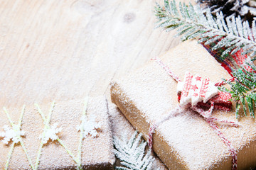 Christmas presents and snow on wooden background, retro style with copy space