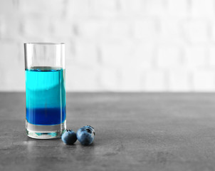 Colorful shot with blueberries on gray table