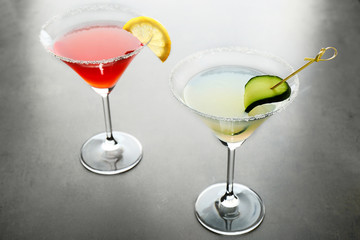 Different cocktails on gray table