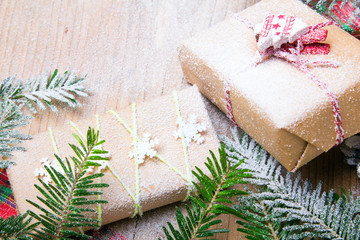 Christmas presents and snow on wooden background, retro style with copy space