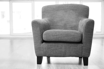 Cozy grey armchair in the room