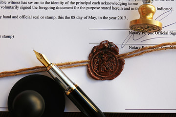 Old notarial wax seal and stamp on document, closeup