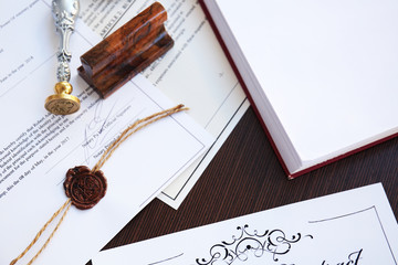 Wax seal, stamp and documents on table