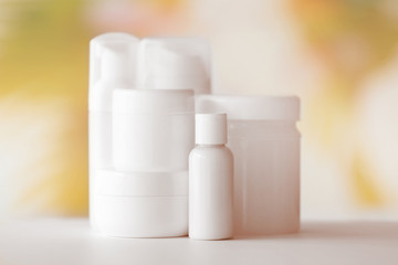 Set of cosmetics on white table against blurred background, close up view