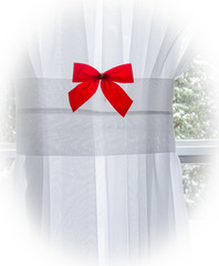 Red Christmas Bow on a window curtain with Vignette
