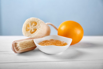 Beauty treatment and body care. Set of body scrub and bath accessories on wooden table