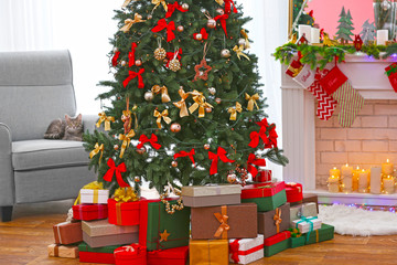 Beautiful Christmas tree with presents in living room