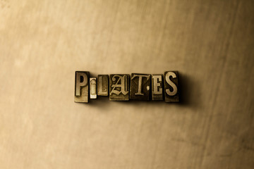 PILATES - close-up of grungy vintage typeset word on metal backdrop. Royalty free stock - 3D rendered stock image.  Can be used for online banner ads and direct mail.
