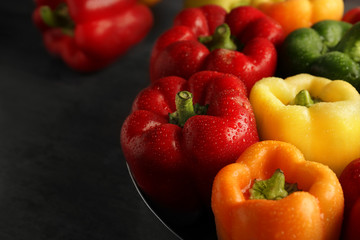 Red, green and yellow sweet bell peppers on table, close up