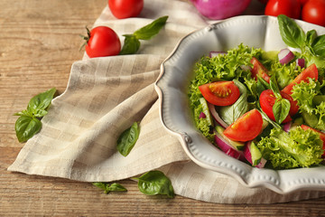 Tasty vegetable salad on kitchen table