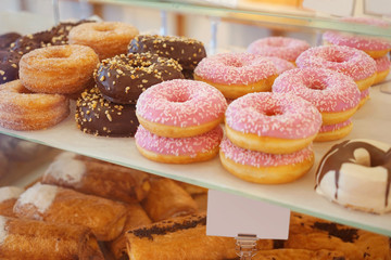Delicious donuts on store shelves closeup
