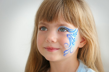 Fototapeta premium Little girl with aqua makeup on light background
